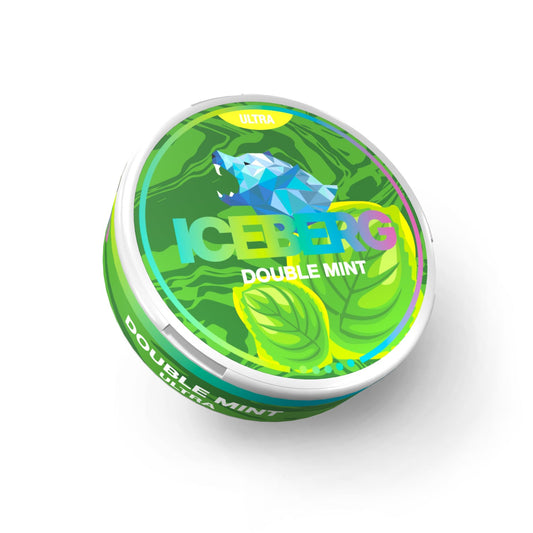 Detail close-up of a circular mint candy tin featuring a colorful design with mint leaves in green, blue, and white.