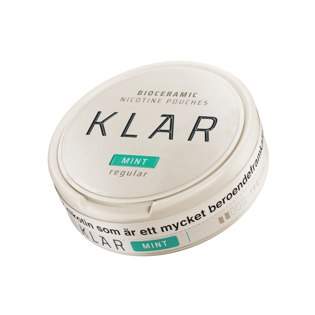 Detail close-up of the round teal Klar cream container with a screw top, showcasing label text on a white background.